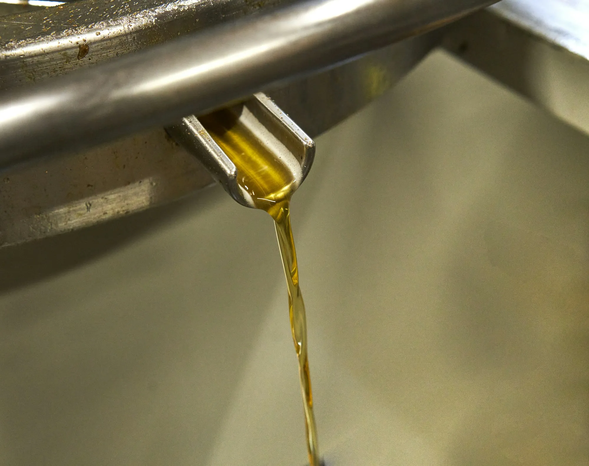 Motor oil pouring from a bottle into an engine